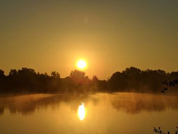 View of calm lake at sunset