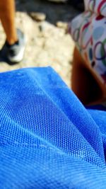 Close-up of hand on blue wall