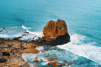 High angle view of rocks on sea shore