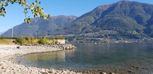 Scenic view of sea and mountains against sky