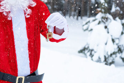 Rear view of woman holding snow