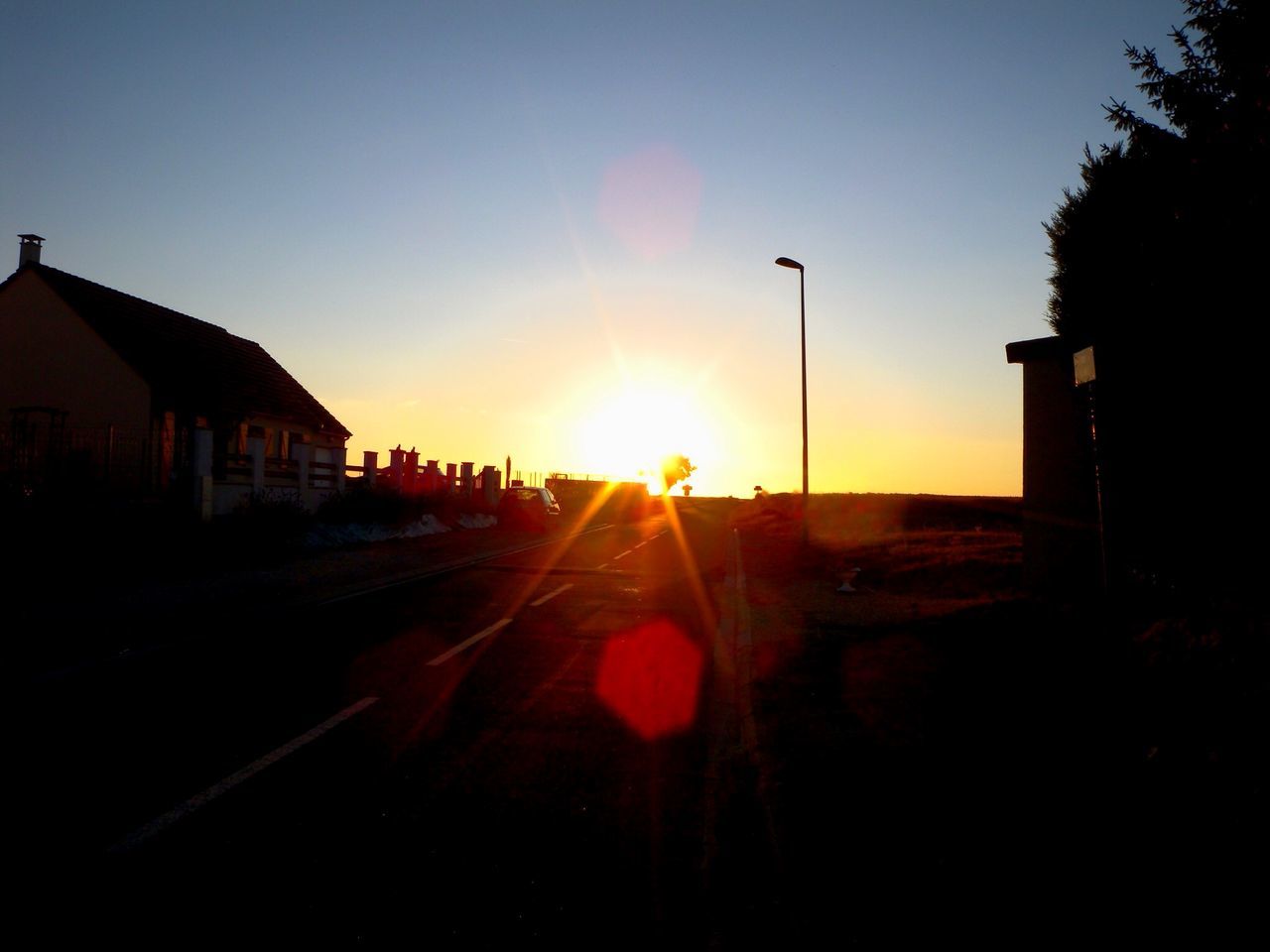 sunset, sun, building exterior, built structure, architecture, sunlight, lens flare, sunbeam, clear sky, silhouette, sky, street, city, orange color, copy space, house, outdoors, no people, road, transportation