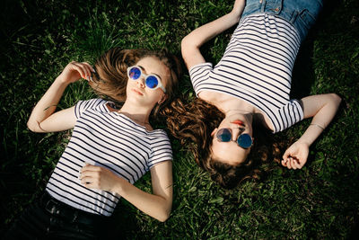 High angle view of friends lying on grass