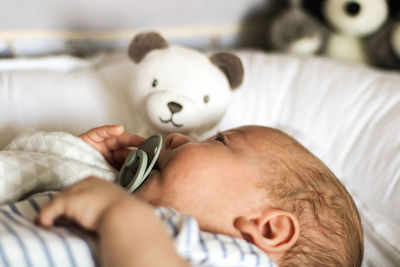 Close-up of man sleeping on bed