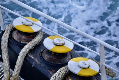 Close-up of metal attachment with rope against sea