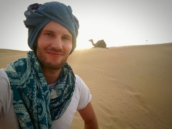 Portrait of young man in desert