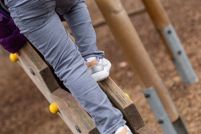 Low section of child playing at playground