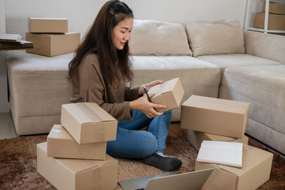 Woman sitting on sofa at home