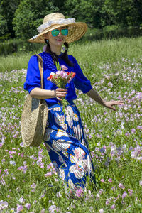 Woman wearing hat while standing on field