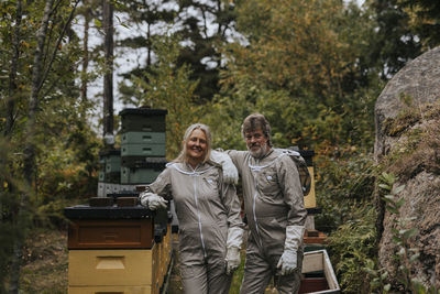 Beekeepers standing near beehive