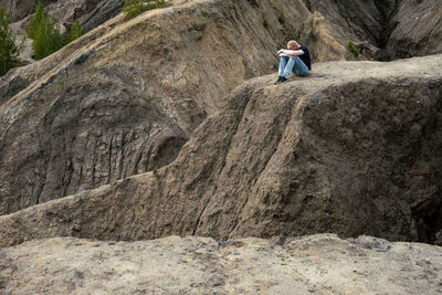 Rear view of man walking on rock