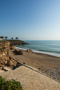 Scenic view of beach against clear sky