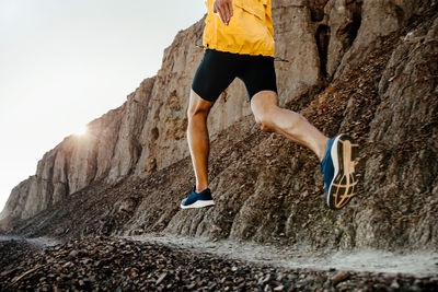 Low section of man running on land