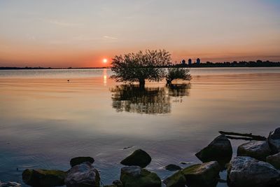 Scenic view of lake against sky during sunset