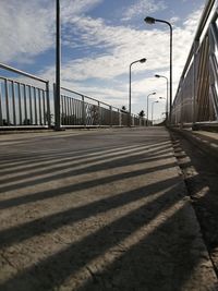 Surface level of road on bridge against sky