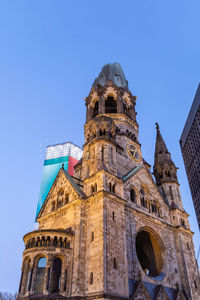 Low angle view of historic building against clear blue sky