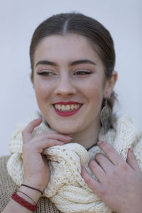 Smiling girl looking away while wearing warm clothing