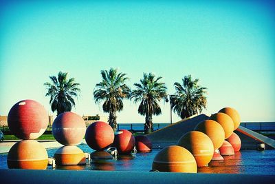 Palm trees against clear blue sky