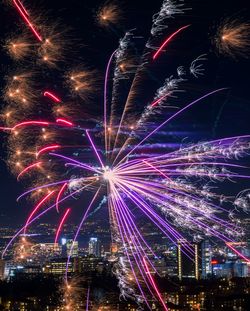 Low angle view of firework display at night