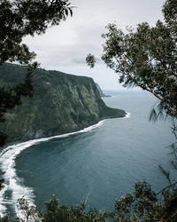 Scenic view of waterfall against sky