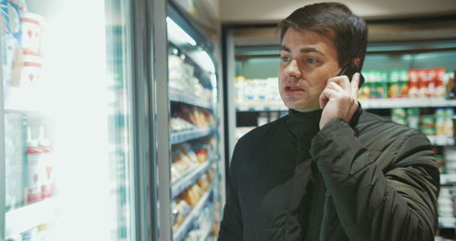 Portrait of man standing in store