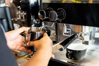 Cropped image of hand holding coffee cup