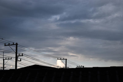 Low angle view of silhouette bridge against sky