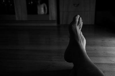 Low section of woman resting on floor