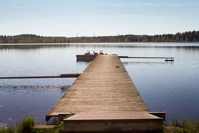 Pier over lake against sky