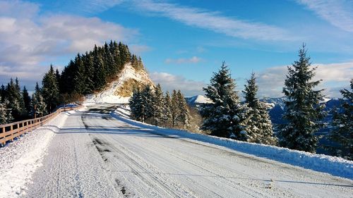 Snow covered road against sky