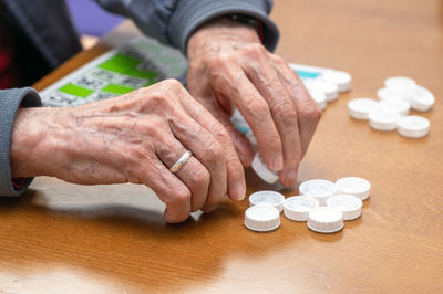 Cropped image of man holding pills