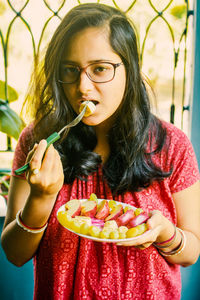 Portrait of young woman eating food. women need quality food for diet.