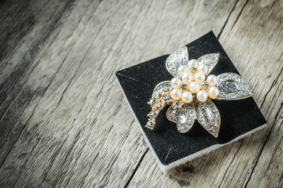 Close-up of diamond jewelry with sponge on table