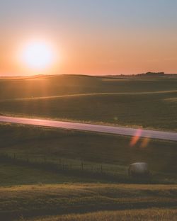 Scenic view of field against sky during sunset