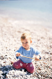 Full length of cute boy on beach