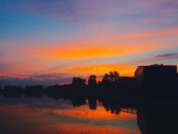 Scenic view of lake against orange sky