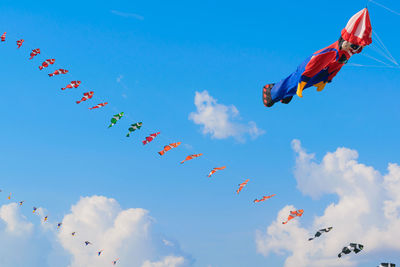 Low angle view of flags against sky