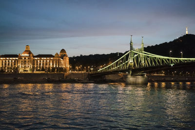 Danube river at night with danubius hotel gellért and liberty bridge