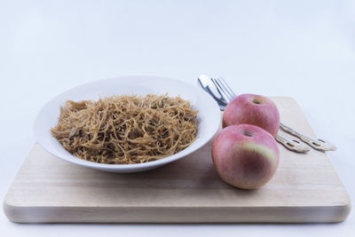 Fruits and vegetables on cutting board on table