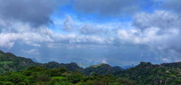 Panoramic view of trees and mountains against sky