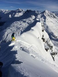 Tourists on snow covered mountain