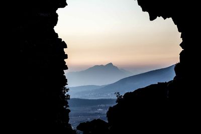 Scenic view of silhouette mountains against sky