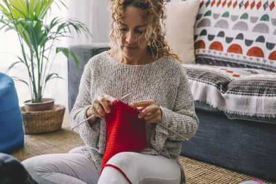 Woman crocheting at home