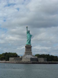 Low angle view of statue against cloudy sky