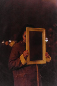 Reflection of woman photographing in mirror