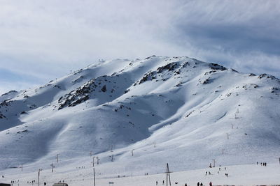 Scenic view of snow covered mountains against sky