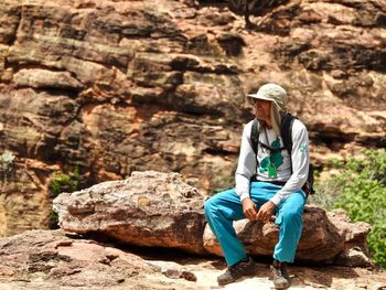 Man sitting on rock