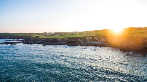 Scenic view of sea against clear sky during sunset