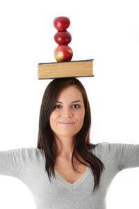 Portrait of smiling young woman against white background