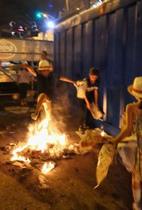 Group of people in fire at night